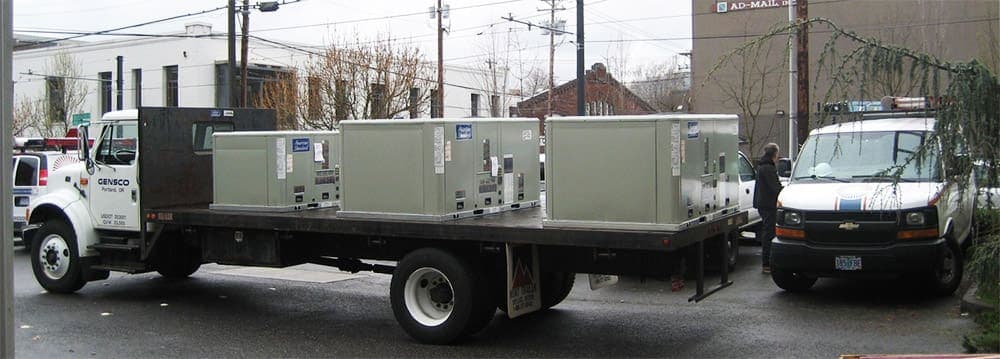 Commercial HVAC technician servicing rooftop unit in Portland